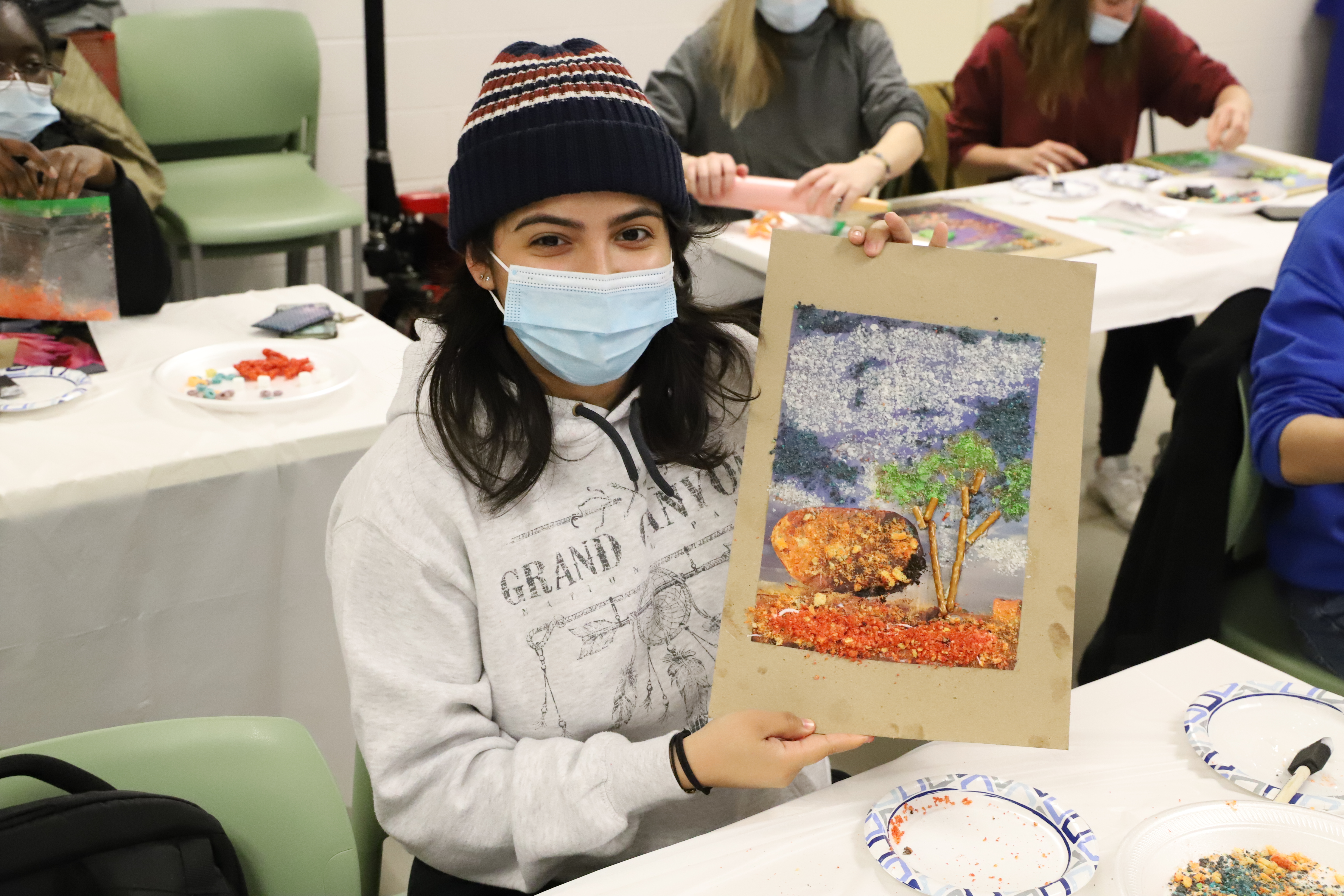 Student Displaying Art Piece